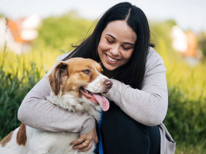 Woman sitting with her dog outside